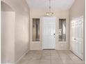 Bright entryway with tile flooring and coat closet at 8630 W Melinda Ln, Peoria, AZ 85382