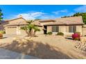 House exterior showcases desert landscaping and two-car garage at 8630 W Melinda Ln, Peoria, AZ 85382