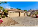 Two-car garage and front yard view of house exterior at 8630 W Melinda Ln, Peoria, AZ 85382