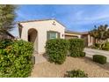 Front view of charming house with lush green bushes at 9658 E Tahoe Cir, Mesa, AZ 85212