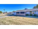 Brick ranch house with a screened patio and yard at 9909 W Newport Dr, Sun City, AZ 85351