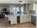 Modern kitchen with island, stainless steel appliances, and white cabinetry at 9992 E Carol Ave, Scottsdale, AZ 85258