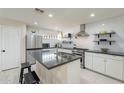 Modern kitchen with white cabinets, stainless steel appliances, and an island at 1001 N Burk St, Gilbert, AZ 85234