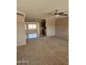 Spacious living room with tile flooring and a ceiling fan at 10546 W Catalina Dr, Arizona City, AZ 85123