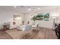 Bright living room featuring a large sectional sofa, hardwood floors, and ample natural light at 1164 E Westchester Dr, Tempe, AZ 85283