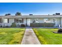 Single-story home with a well-maintained lawn and walkway at 13635 N 111Th Ave, Sun City, AZ 85351