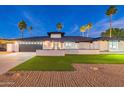 Beautiful contemporary home with a modern facade and lush lawn at 14241 N 54Th St, Scottsdale, AZ 85254