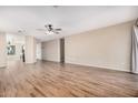 Open living room with wood-look floors and views into kitchen area at 14352 W Lamoille Dr, Surprise, AZ 85374