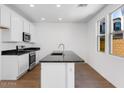 Modern kitchen featuring stainless steel appliances, granite countertops, and white cabinets at 14644 W Sand Hills Rd, Surprise, AZ 85387