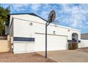 Front view of a white house with a garage and basketball hoop at 1506 E Topeka Dr, Phoenix, AZ 85024