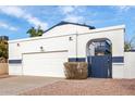 Two-story house with white exterior, arched entry, and a garage at 1506 E Topeka Dr, Phoenix, AZ 85024