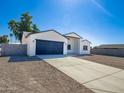 Newly built home with a modern exterior, two-car garage, and spacious driveway at 15235 S Country Club Dr, Arizona City, AZ 85123