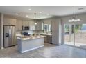 Modern kitchen featuring gray cabinets, stainless steel appliances, and an island at 15235 S Country Club Dr, Arizona City, AZ 85123