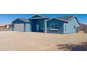 Newly built home with blue exterior, white garage door, and gravel driveway at 15245 S Country Club Dr, Arizona City, AZ 85123