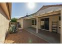 Covered patio, gravel landscaping, and mature agave plant at 15513 W Coral Pointe Dr, Surprise, AZ 85374