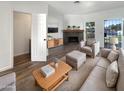 Bright living room with fireplace and wood-look floors at 1601 N Saba St # 306, Chandler, AZ 85225