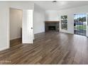 Spacious living room featuring a fireplace and wood-look floors at 1601 N Saba St # 306, Chandler, AZ 85225