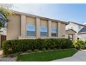 Contemporary home with light-colored facade and neatly trimmed hedges at 17183 W San Marcos St, Surprise, AZ 85388