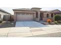 Single-story home with a two-car garage and desert landscaping at 18171 W Glenhaven Dr, Goodyear, AZ 85338