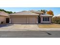 Two-story house with a three-car garage and well-maintained lawn at 21918 N 66Th Ln, Glendale, AZ 85310