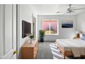 Main bedroom with a large window, plenty of sunlight, and a dresser at 2635 E Desert Wind Dr, Casa Grande, AZ 85194