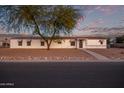 Front view of a manufactured home with mature tree and rock landscaping at 2881 W Cactus Wren St, Apache Junction, AZ 85120