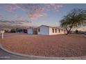 Landscaped manufactured home with gravel driveway and mature tree at 2881 W Cactus Wren St, Apache Junction, AZ 85120