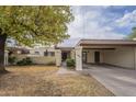 Single-level home with carport and landscaped front yard at 2911 W Lamar Rd, Phoenix, AZ 85017