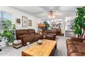 Spacious living room with brown leather couches and a wood coffee table at 4043 W Saguaro Park Ln, Glendale, AZ 85310