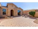 Brick paved courtyard with lounge chairs and a view of the front door at 42899 W Whimsical Dr, Maricopa, AZ 85138