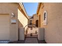 Wrought iron gate leads to the entrance of the house at 42899 W Whimsical Dr, Maricopa, AZ 85138