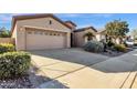 Tan colored stucco home with a two car garage and desert landscaping at 4531 E Jude Ln, Gilbert, AZ 85298