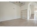 Light-filled living room with built-in shelving and hardwood floors at 532 N Bell Dr, Chandler, AZ 85225