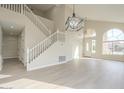 Open living area featuring a grand staircase and hardwood floors at 532 N Bell Dr, Chandler, AZ 85225