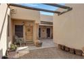 Charming entryway with desert landscape, wooden accents, and a decorative wooden door with star emblem at 5713 W Sun Dance Dr, Queen Creek, AZ 85144