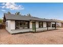 House exterior with a green door and well-maintained landscaping at 615 W Enid Ave, Mesa, AZ 85210