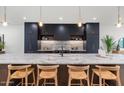 Modern kitchen with marble countertops and dark cabinetry at 6916 E 2Nd St, Scottsdale, AZ 85251