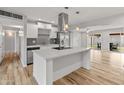 Modern kitchen with white cabinets, a large island, and stainless steel appliances at 7443 E Taylor St, Scottsdale, AZ 85257