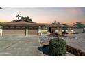 House exterior featuring a two-car garage and landscaping at 7550 E Ironwood Ct, Scottsdale, AZ 85258