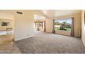 Spacious living room, view of backyard, carpeted floor at 7550 E Ironwood Ct, Scottsdale, AZ 85258