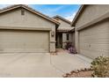 House exterior featuring a three-car garage and walkway at 7606 E Globemallow Ln, Gold Canyon, AZ 85118