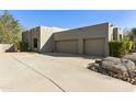 Three-car garage with large concrete driveway at 9580 E Southwind Ln, Scottsdale, AZ 85262