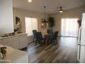 Dining area with glass table and chairs, adjacent to kitchen at 12221 N 122 Dr, El Mirage, AZ 85335