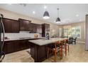 Modern kitchen with dark cabinetry, a large island, and stainless steel appliances at 1536 W Blaylock Dr, Phoenix, AZ 85085