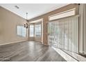 Dining area with wood-look floors and large windows at 15653 W Monterey Way, Goodyear, AZ 85395