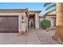 House entrance with a brown door and wrought iron gate at 15653 W Monterey Way, Goodyear, AZ 85395