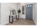 Bright entryway with gray door, console table, and mirror at 16831 S 14Th Ln, Phoenix, AZ 85045