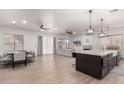 Open concept kitchen and dining area with modern island and breakfast bar at 16831 S 14Th Ln, Phoenix, AZ 85045