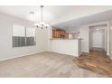 Bright dining room with carpeting and kitchen views at 1749 W Desert Mountain Dr, San Tan Valley, AZ 85144