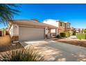 House exterior with gray garage door and driveway at 1749 W Desert Mountain Dr, San Tan Valley, AZ 85144